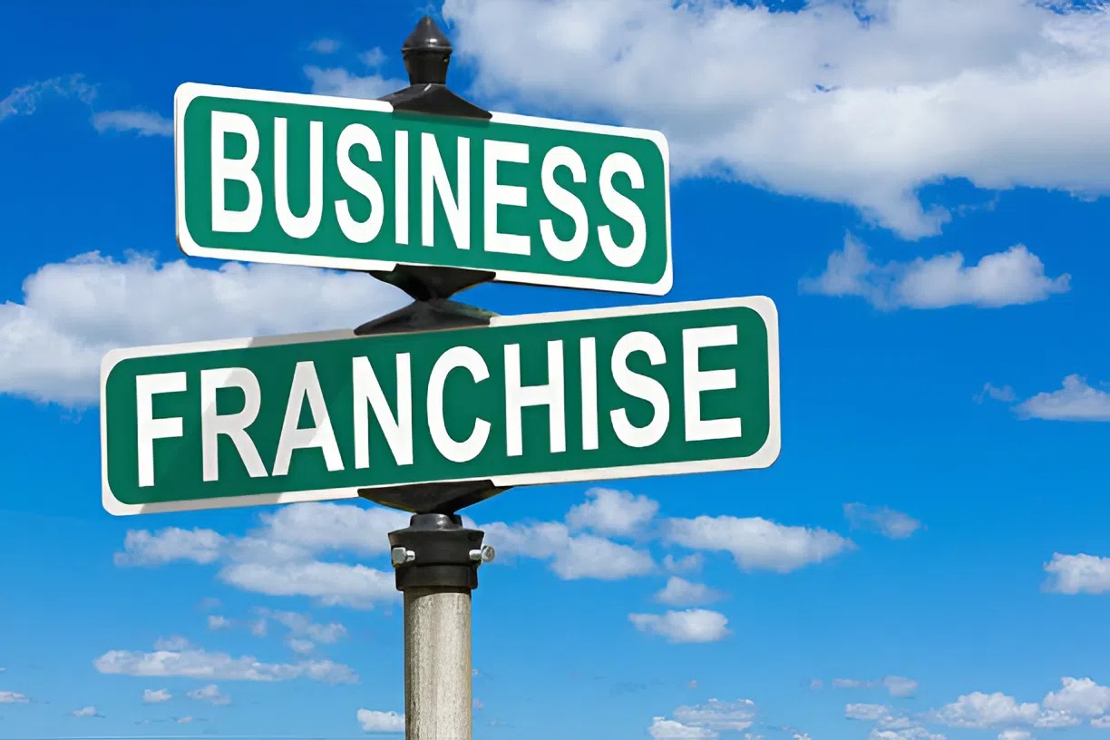 Street sign pointing to a business franchise